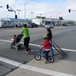 Seaside - young biker with moms in crosswalk