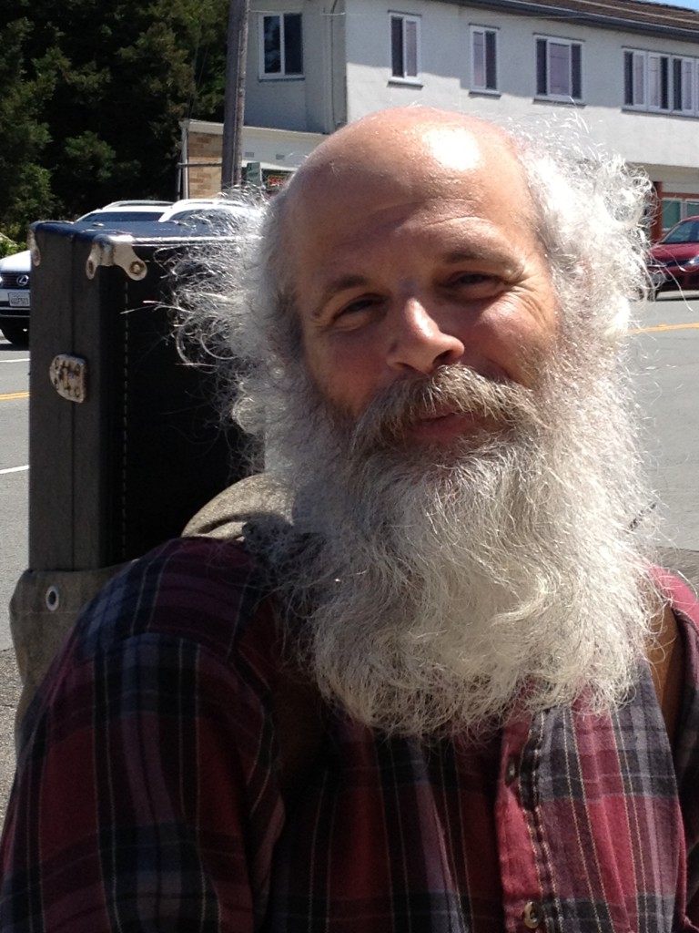 Greybeard saxaphonist with smiling eyes