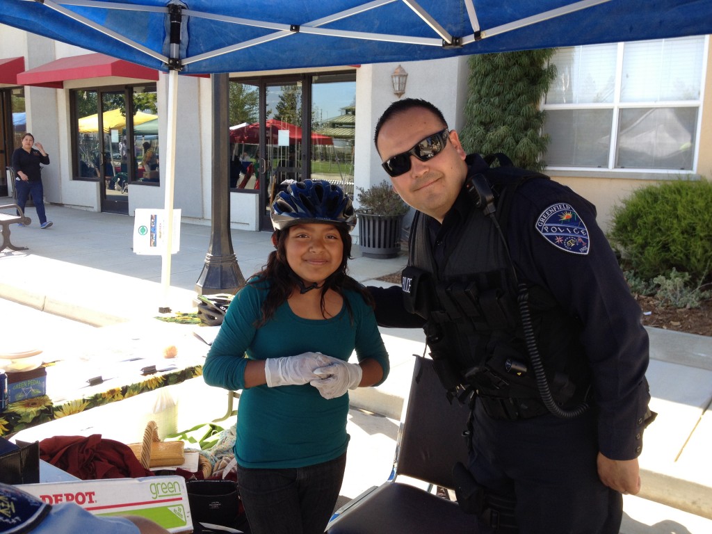 Girl fitted for helmet by Greenfield PD 2012