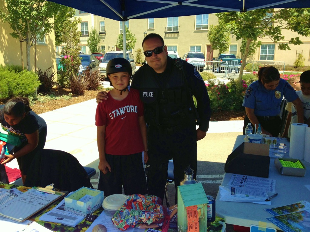 Greenfield boy and PD - fitted for helmet at bike resources booth 2012